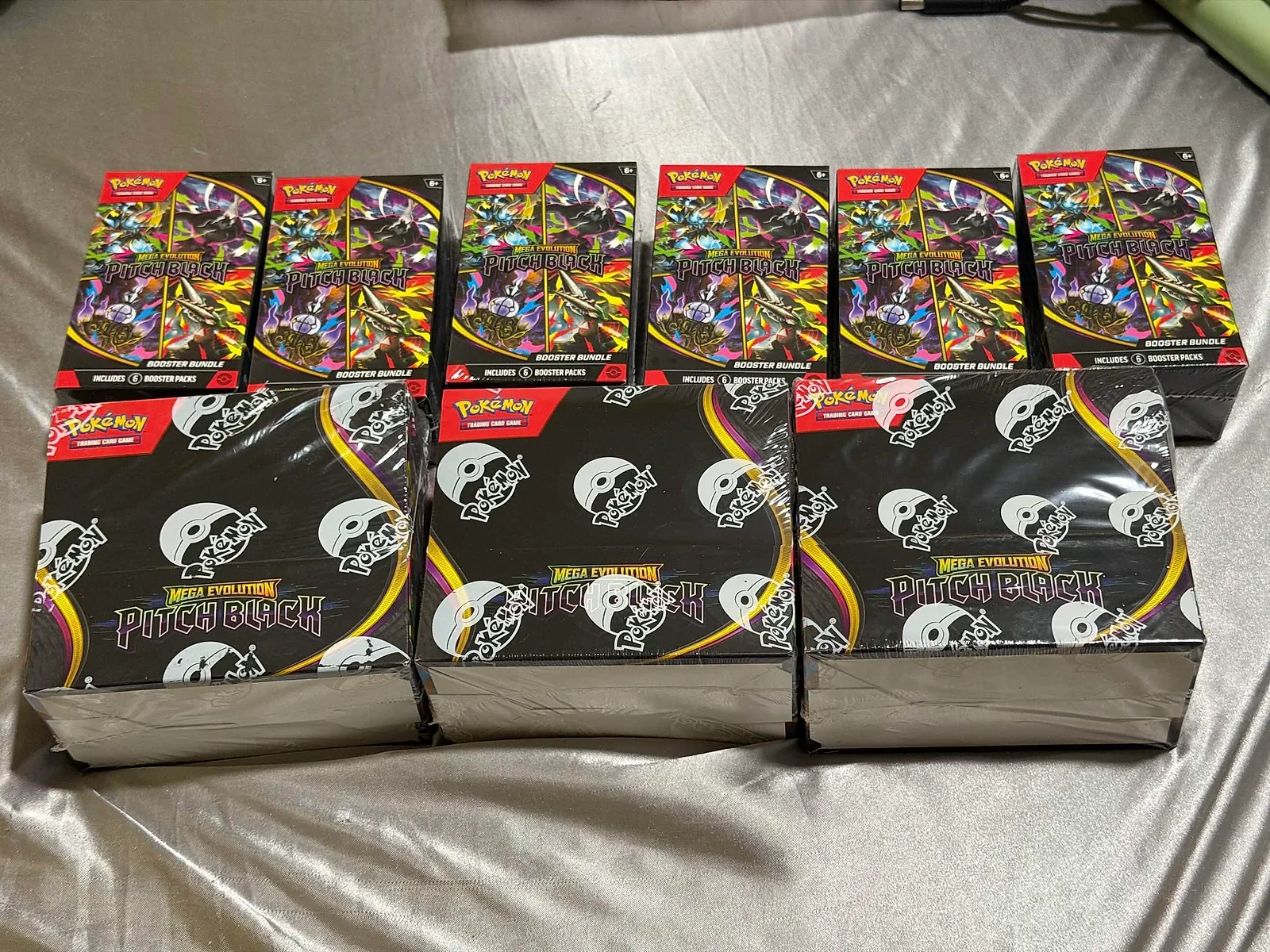 Member-supplied photo of six Pitch Black Booster Bundles and three sealed Pitch Black Booster Display Boxes after fulfillment